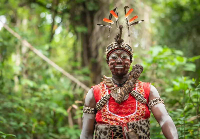 A Missoko Bwiti nganga in ceremonial dress and face paint in the Gabonese forest
